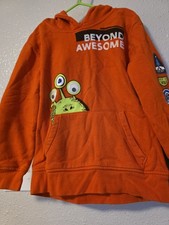 A red children's hooded with a "Beyond Awesome graphic