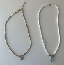 2 beach inspired necklaces with a starfish and a blue pendant
