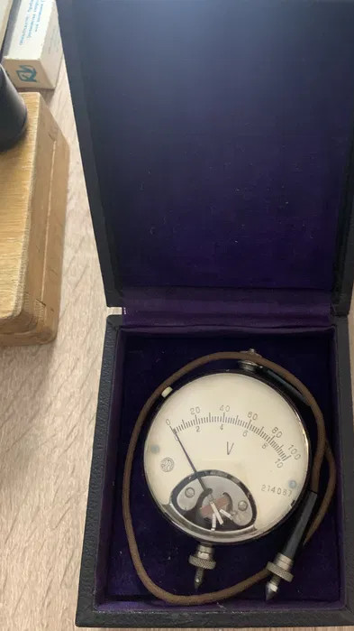 A 1930s pocket scientific voltmeter in its original case — a steampunk-era precision instrument that looks like a prop from a Nikola Tesla biopic.