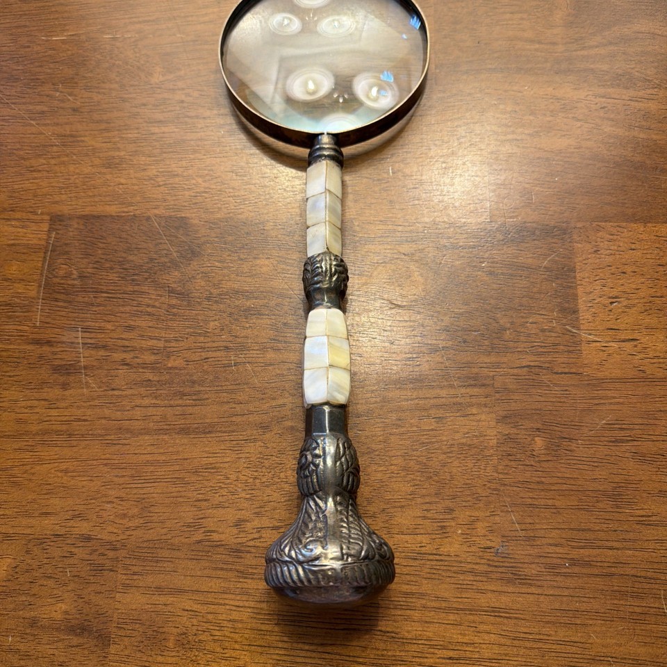 A 12-inch antique brass and mother-of-pearl magnifying glass map reader — a genuine Victorian instrument that's as beautiful as it is functional.