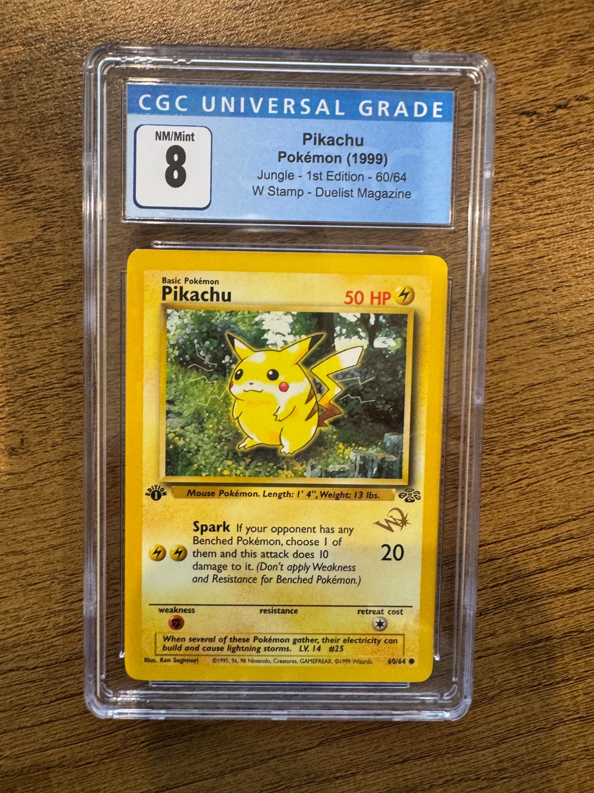 Pikachu Jungle First Edition 60/64. W Stamp - Duelist Magazine Grade 8 NM/Mint