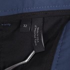Black fabric tag on waistband of blue 32 slim fit THEORY men’s dress pants, reading “Made in U.S.A.”