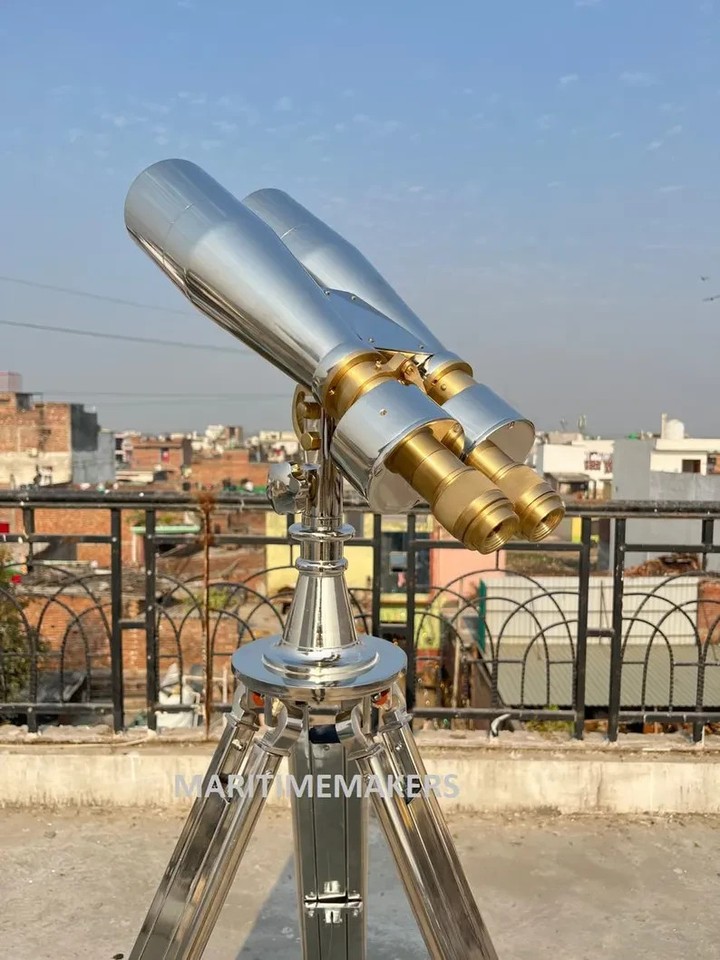 Polished nickel 1920s-style 15x80 maritime binoculars mounted on a tripod — a genuinely dramatic, display-worthy nautical artifact.