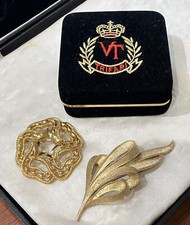 Vintage Trifari black velvet clamshell box, and 2x Trifari gold  brooches
