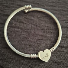 Stainless steel cable bracelet with a heart charm engraved with the initial "A".
