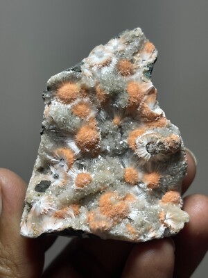 Multiple orange mesolite ball on matrix