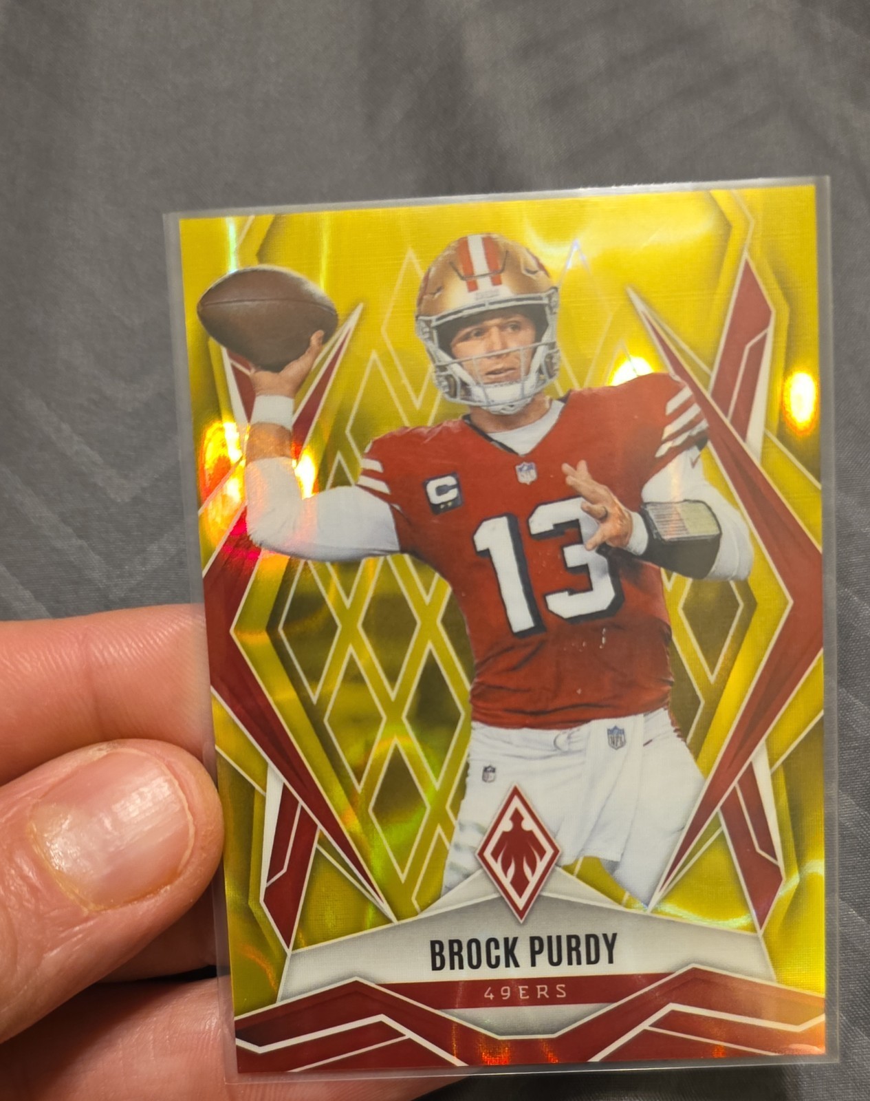 2025 Panini Phoenix - Brock Purdy #33 Yellow Lava /125