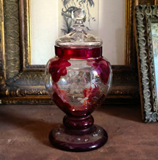 A vintage Mary Gregory-style cranberry glass, lidded apothecary Jar