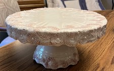Cream ceramic pedestal cake stand floral  lace embossed pattern rim  base.