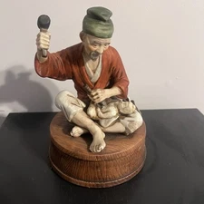 Lionstone Whiskey Decator Old Man Carving A Baby Sitting On A Barrel ￼
