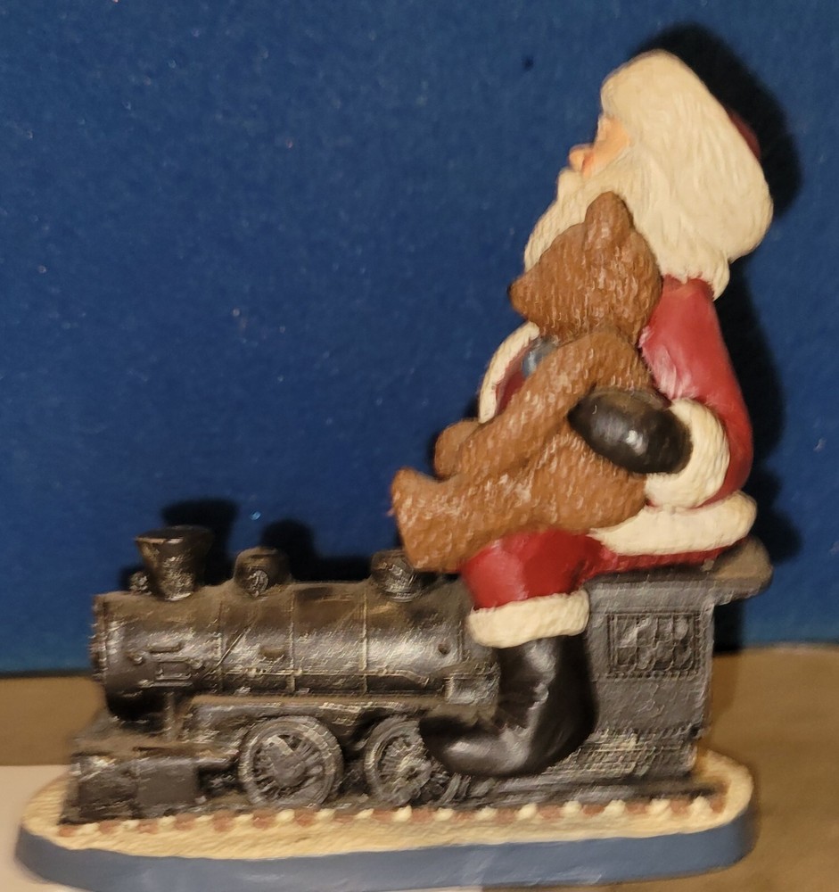 Santa On A Train Holding A Teddy Bear Figurine. 6 in