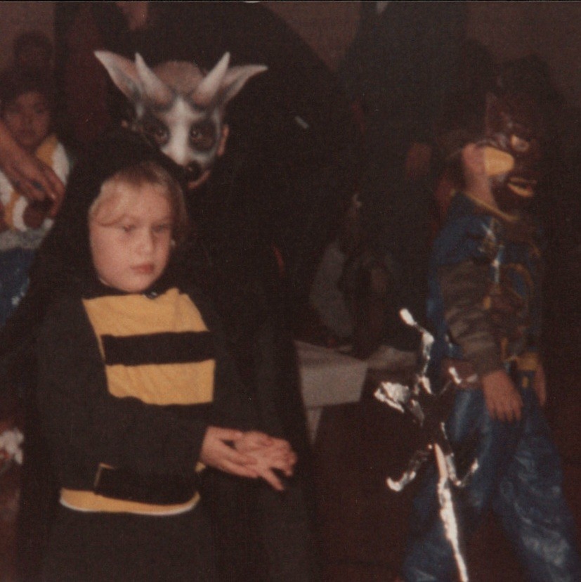 A genuinely unsettling 1980s photo of a terrified kid in a bumblebee costume that somehow crosses into full demon-child territory — peak vintage Halloween weird.