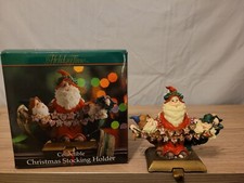 Vintage Holiday time cast iron santa stocking holder