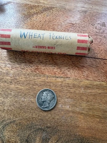 1916 w mercury dime and a roll of wheat pennies