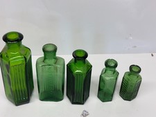 COLLECTION OF 5 GREEN MEDICINE BOTTLES.