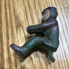 Vintage cast iron toy figure, a passenger or driver for a horse-drawn buggy  .