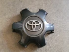 Genuine OEM 2016-2023 Toyota Tacoma Dark Charcoal center cap P/N 4260B-04050