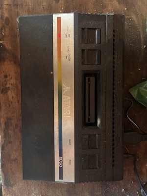 Atari 2600 Black Video Game Console With One Controller And Two Boxed Games.