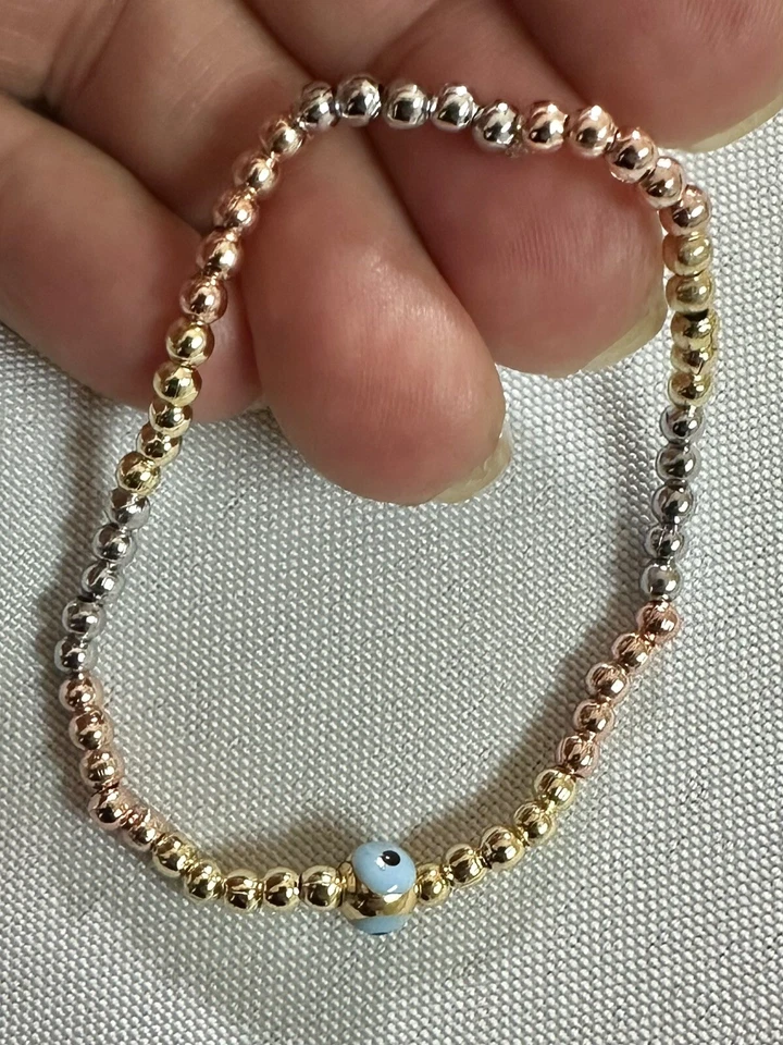 Brazalete Evil Eye relleno de oro, relleno de oro rosa y bolas de plata con banda elástica Foto 2 de 2