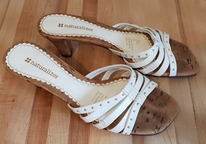 white heels with gold accents