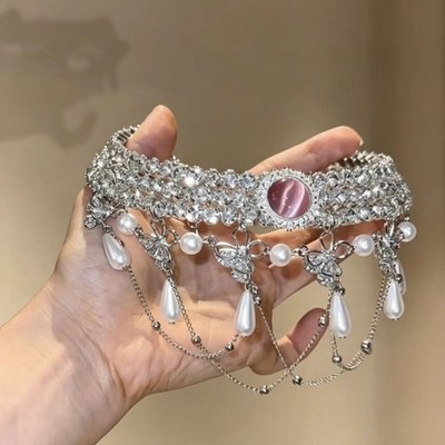Full-pavé rhinestone collar necklace featuring a pink cat's-eye stone, teardrop 
