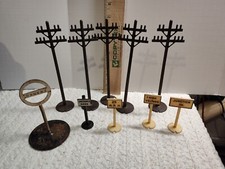 Model railroad items: 5- 7" Tall telephone poles Small signs and spring Sign