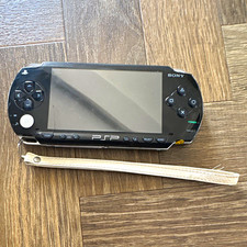 Sony PSP-1003 Black Handheld Console Wi-Fi + Carry Case + Tomb Raider UMDs