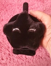 Black fluffy star . Ear Muffs In good Condition with eye lashes.