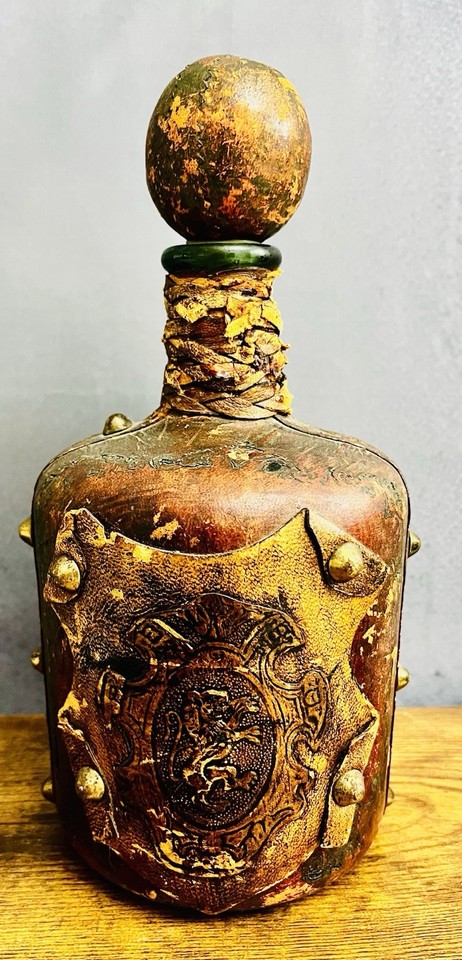 A sculpted Italian medieval knight decanter in deep green glass with a wooden stopper — the kind of barware that demands a double-take on any bar cart.