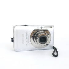 Canon PowerShot SD1300 IS 12.1MP Compact Camera Silver debris in lens 