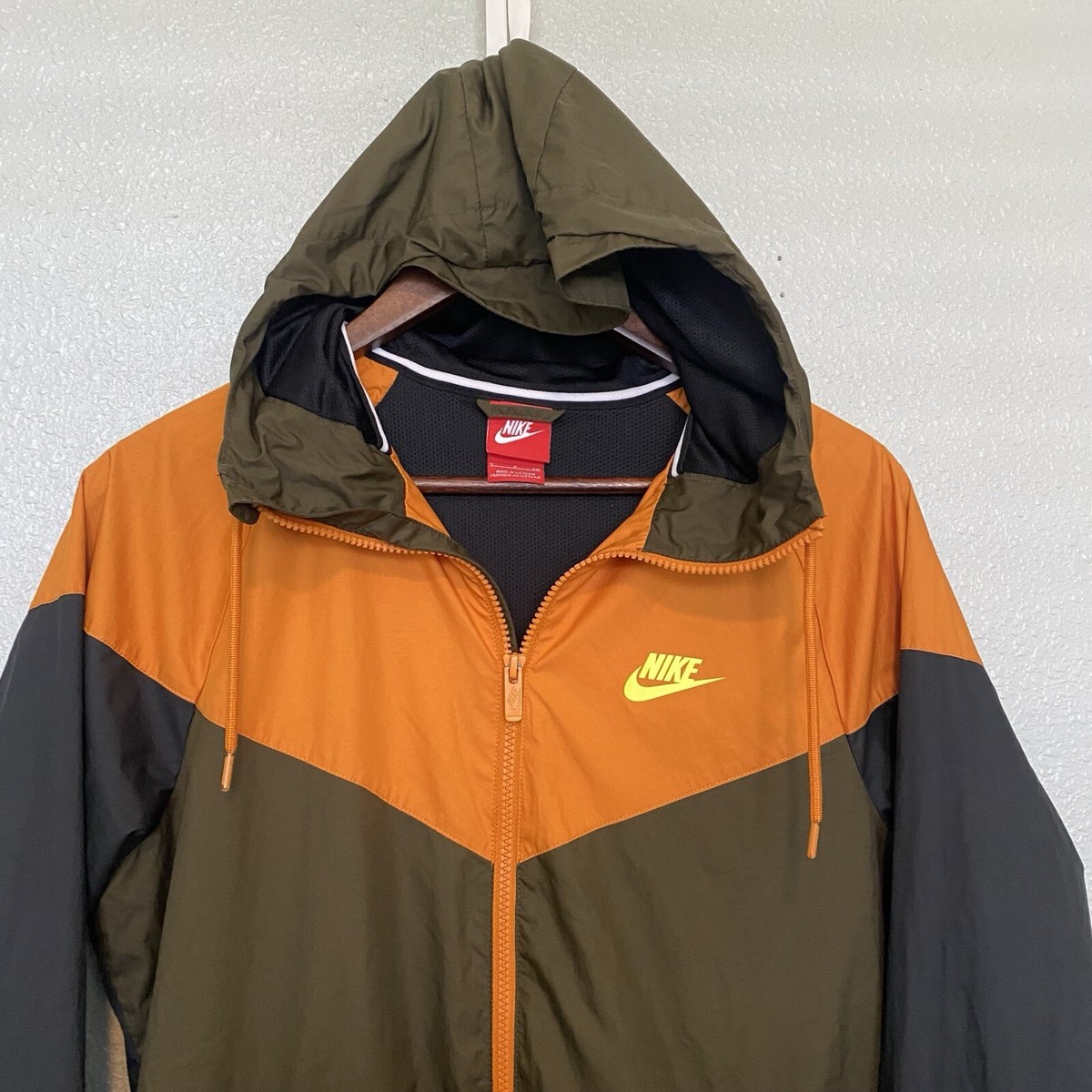 olive green and orange nike jacket