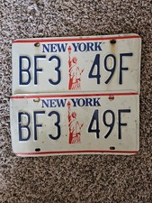 RETIRED New York State license Plates ( 2) featuring statue of liberty.