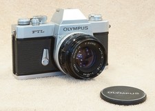 Vintage jammed/broken Olympus FTL film camera w/ F. Zuiko 50mm f1.8 lens cap