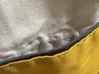 Gray and gold striped fabric of WAMSUTTA ULTRACALE pillowcase with dark brown trim and stitched edges.