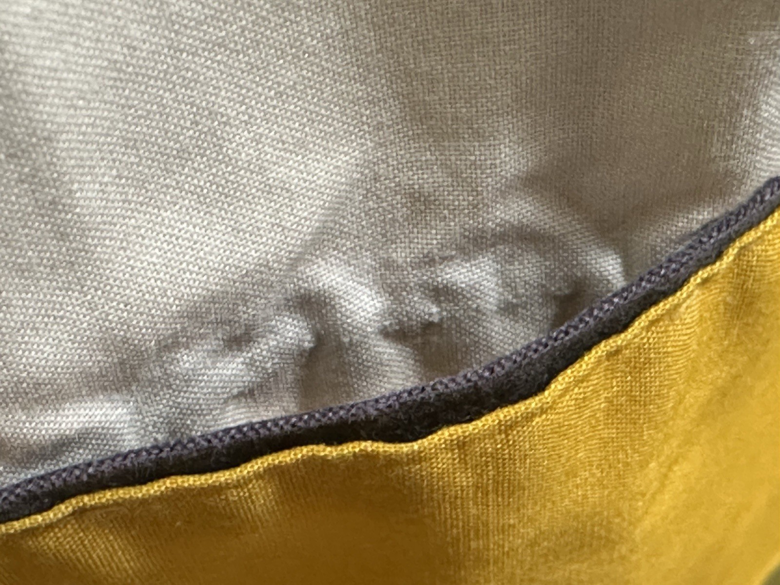 Gray and gold striped fabric of WAMSUTTA ULTRACALE pillowcase with dark brown trim and stitched edges.
