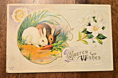1916 Vintage Embossed Easter Greetings Rabbits with Carrot Flower Motif Postcard