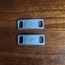 Authentic Nike Air Force 1 metal shoe lace locks, also known as dubraes. Silver