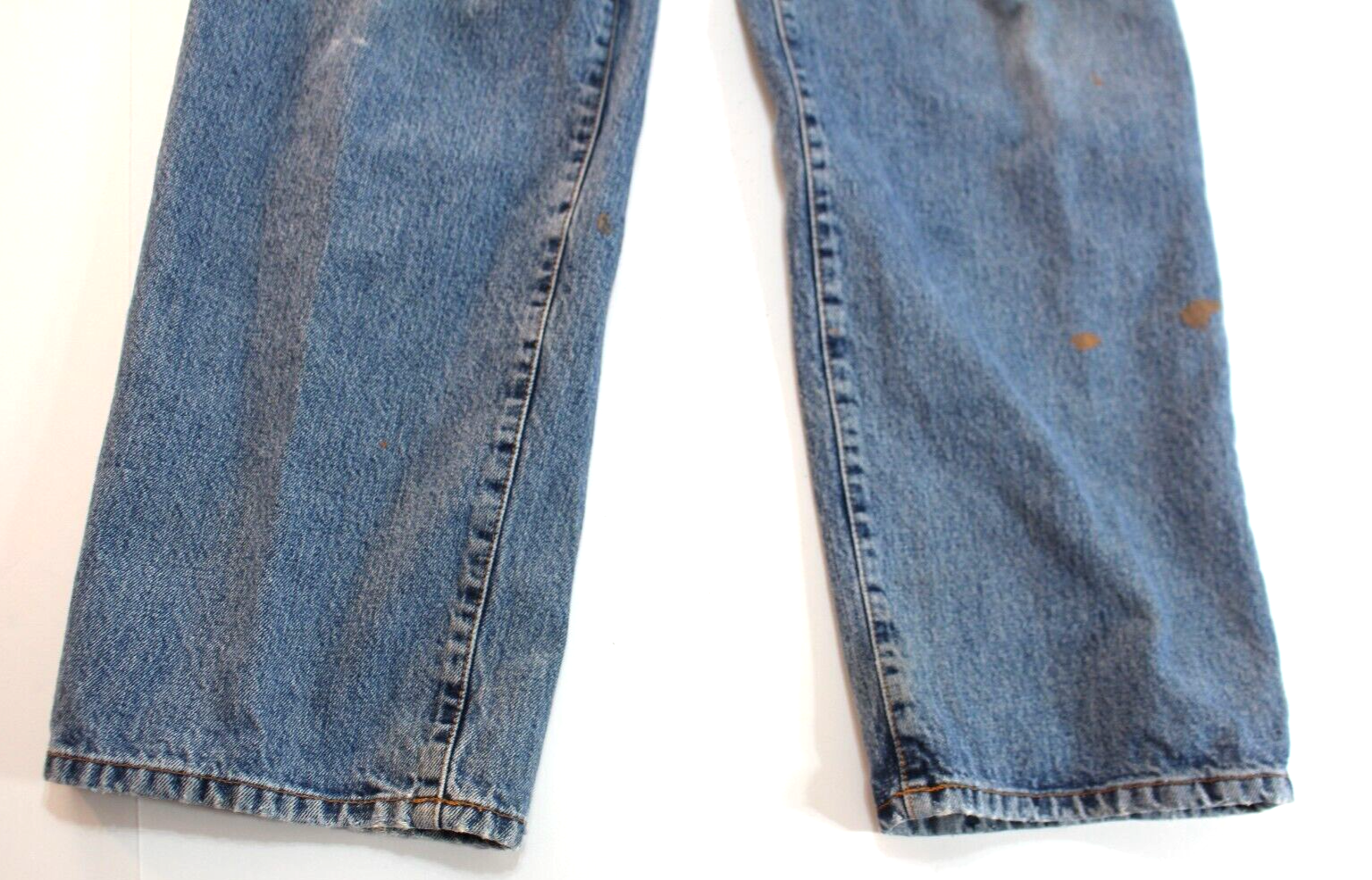 Blue VTG Lucky Brand jeans with 34x30 medium wash, front seam detailing, and brown paint splatter on left leg.