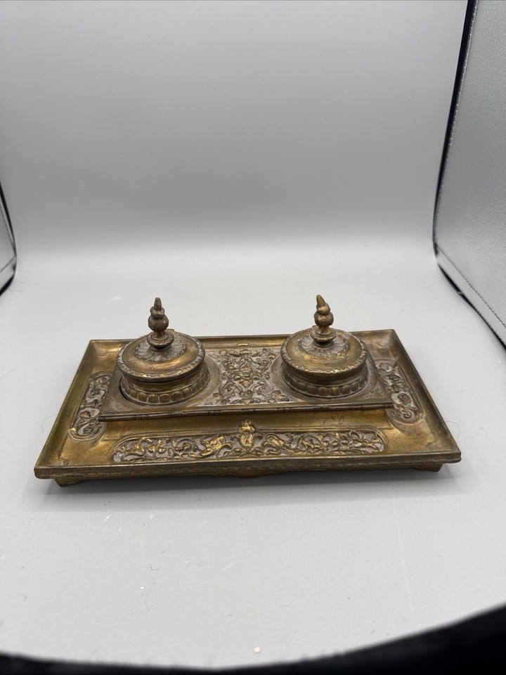 A Victorian brass double inkstand with dip pen holder — a fully functional piece of 19th-century desk history that looks like it belongs in a Sherlock Holmes episode.