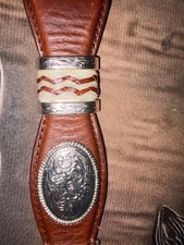 A decorative vintage leather belt by Tony Lama,Western-inspired metal accents.