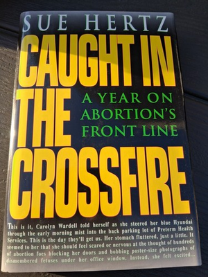 #ad Caught In The Crossfire Sue Hertz $16.99
