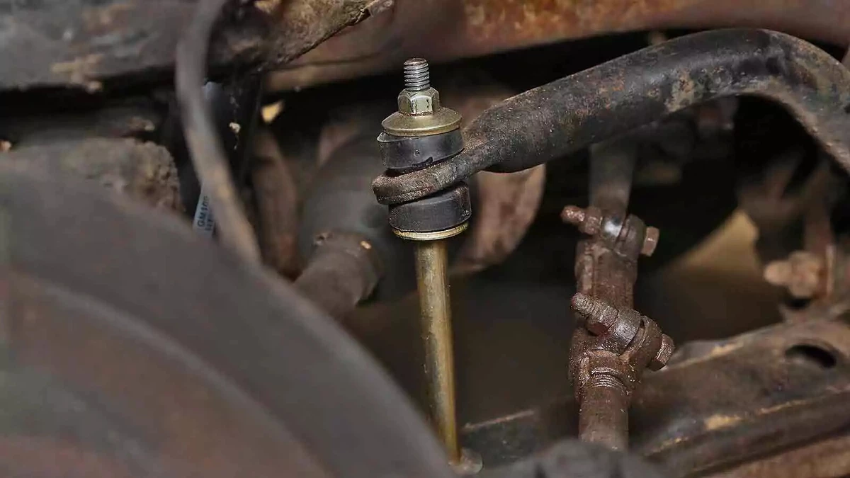 A new sway bar link installed in an older vehicle.