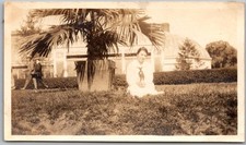 Vtg Snapshot Woman Sitting On Grass By Potted Palm Tree Greenhouse 1920s