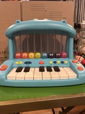 B. Toys Hippo Pop Musical Toy Keyboard Play Piano Songs Sounds Lights Instrument