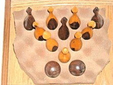 A UNIQUE MINIATURE WOOD BOWLING SET OF 10 PINS AND 2 BALLS