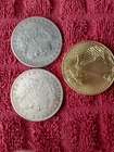 2 Morgan Silver  clad Dollars and a $50 Gold clad Lady Liberty coin.