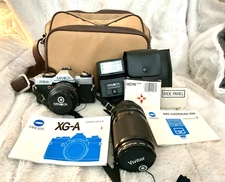 Minolta XG-A SLR 35mm Camera with 55mm Vivitar Zoom, Bag, Filters And Flash