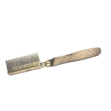 vintage brass straightening comb, known as a hot comb,has a wooden handle.