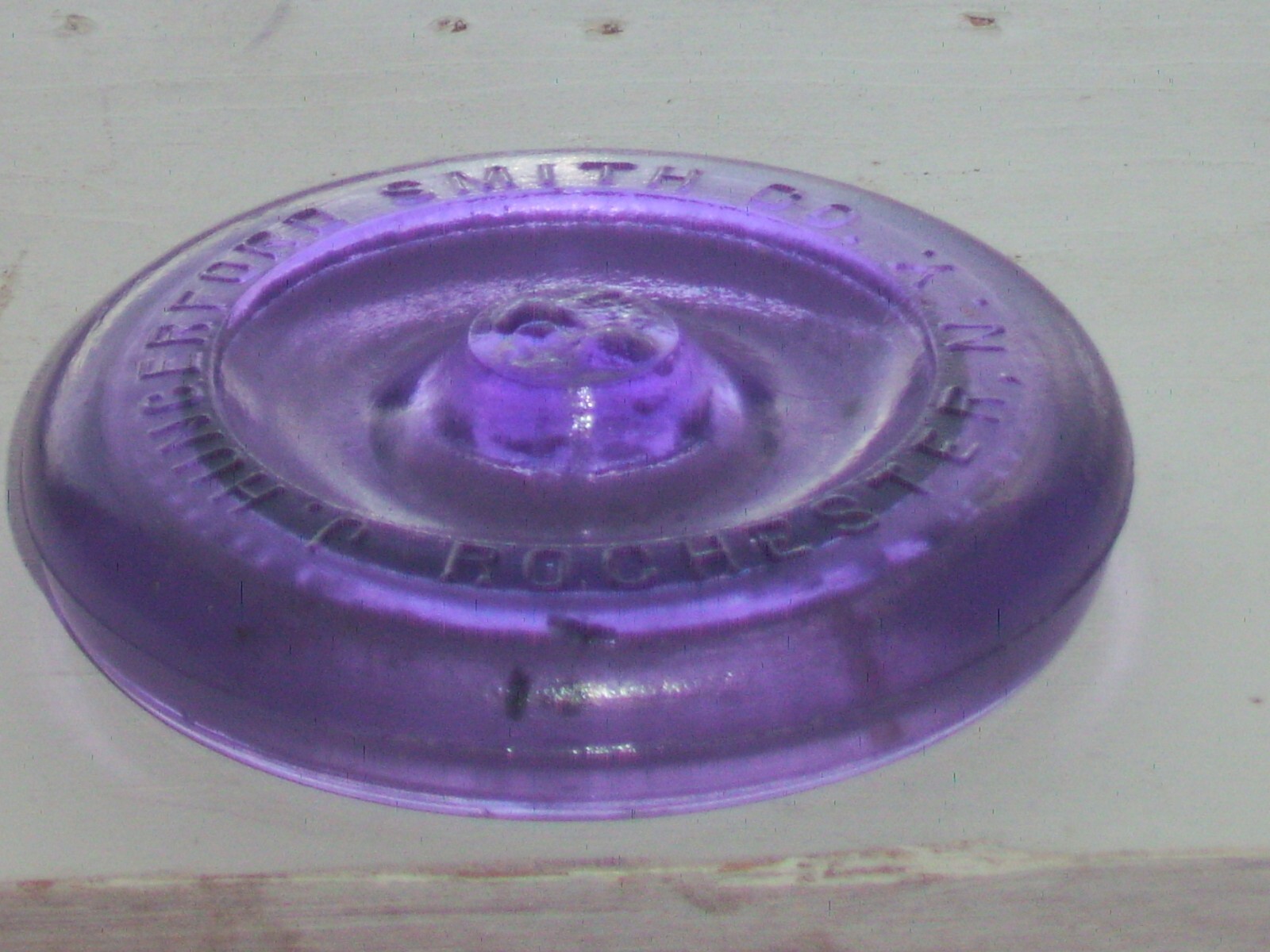 Dark purple J, Hungerford Smith co. Rochester, N. Y. glass top canning jar lid