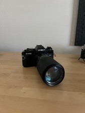 black Minolta x-700 camera with zoom lens 